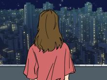 Person looking out on cityscape.