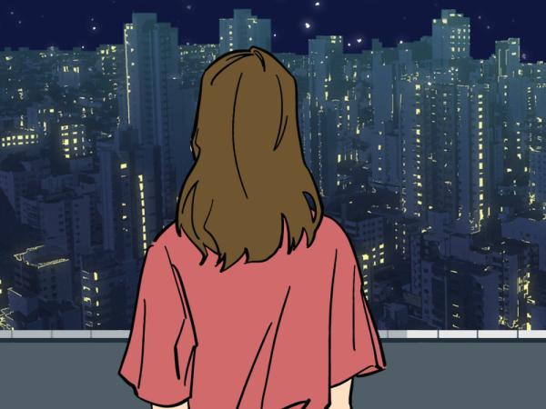 Person looking out on cityscape.